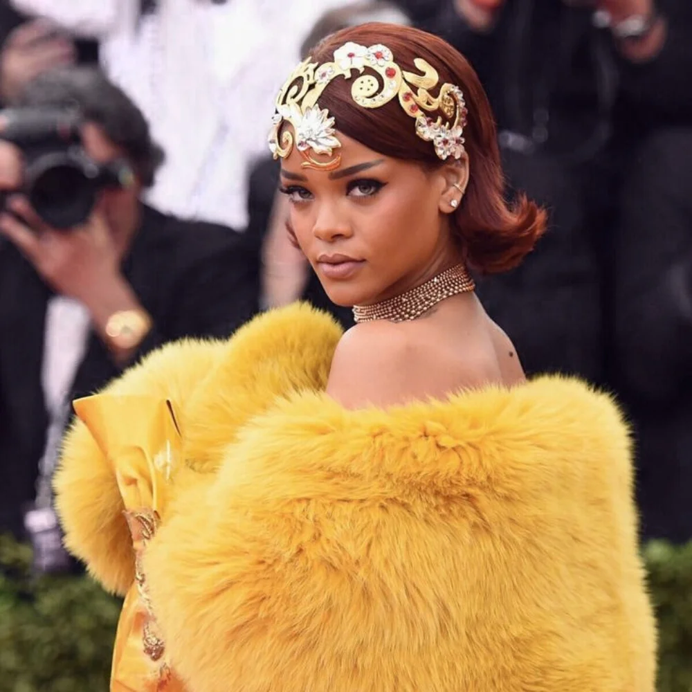 Image of Rihanna in a yellow fur gown with jeweled headpiece at the Met Gala.