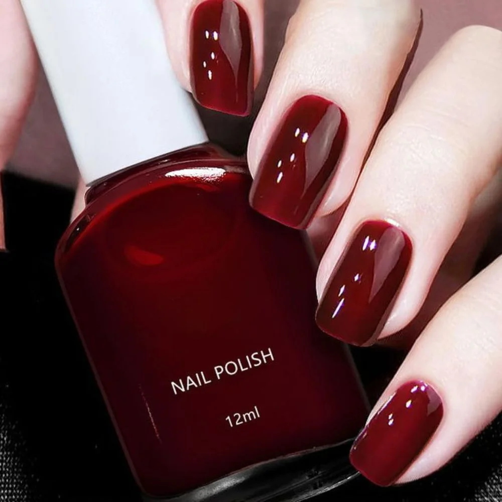 an image of cherry red nails on fair skin