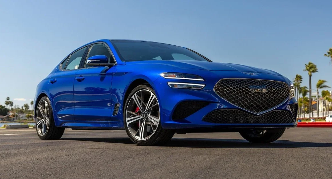 Blue 2025 Genesis G70 sport sedan parked on a sunny street.