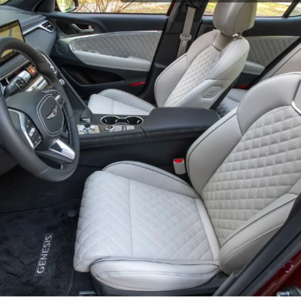 Spacious and comfortable front row of the Genesis G70 with ergonomic seating and refined interior design.
