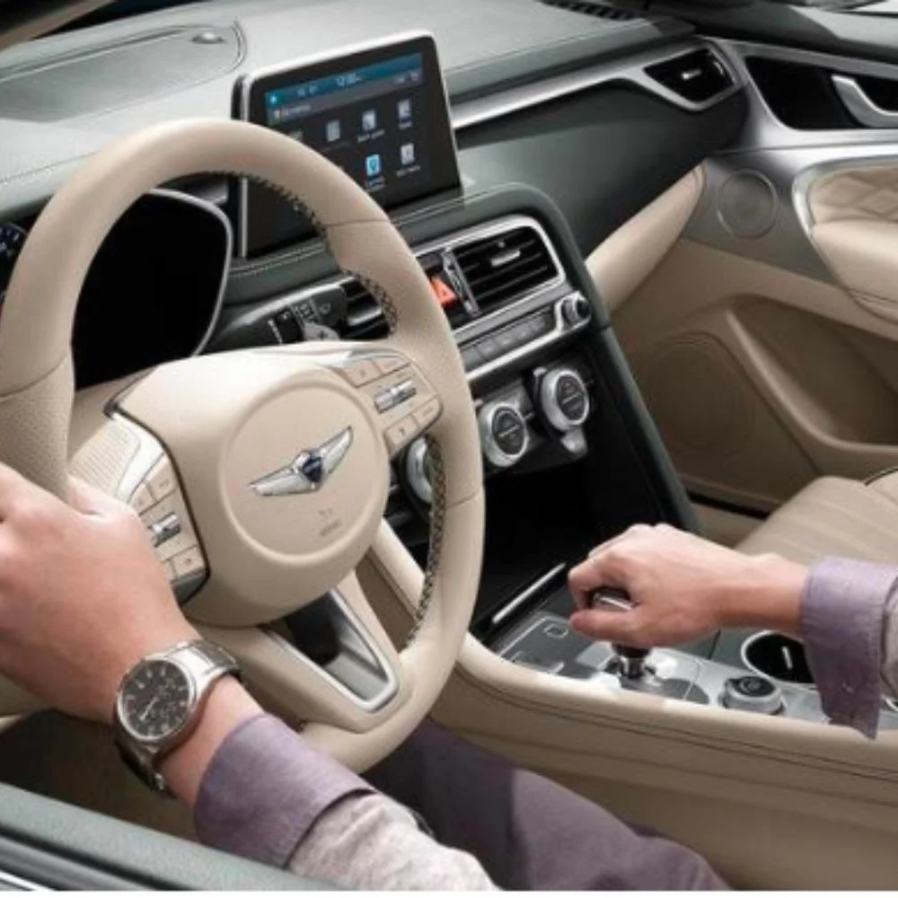 Refined interior layout of the Genesis G70 featuring high-quality materials, intuitive controls, and a driver-focused design.