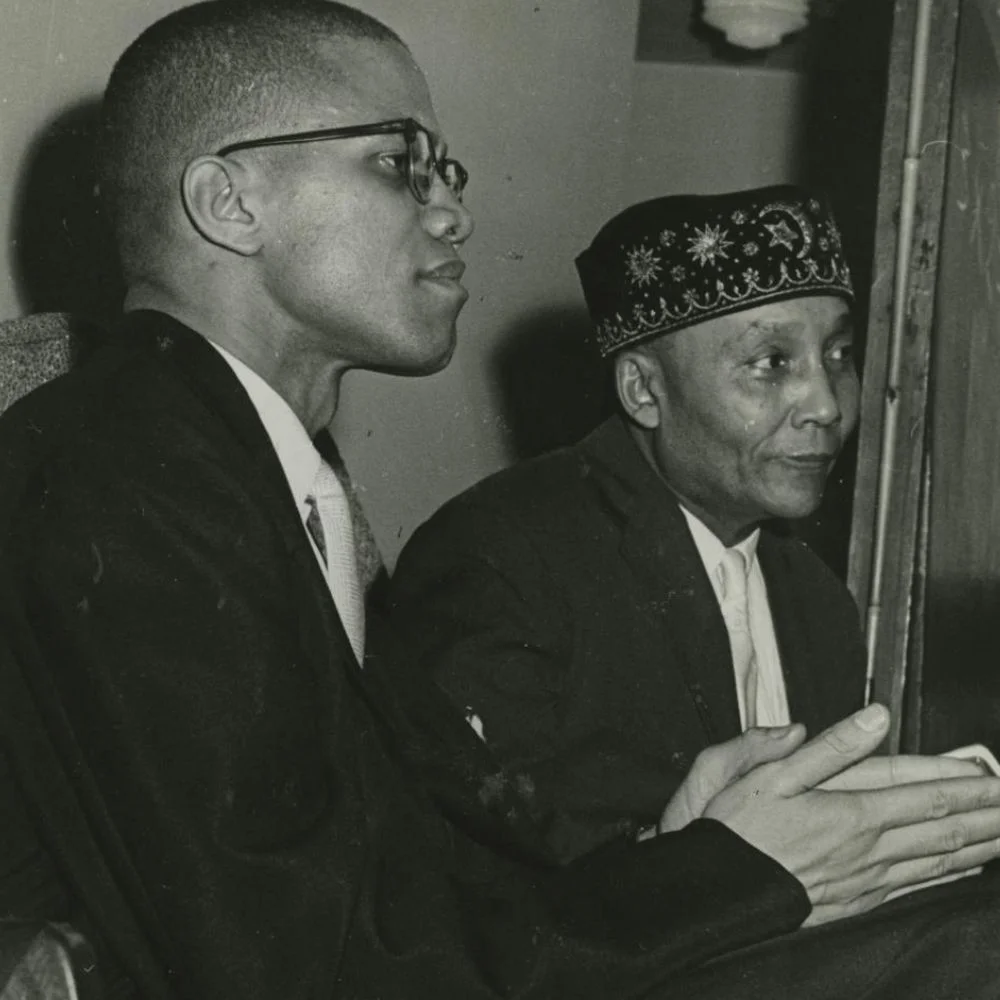 an image of Malcolm X with Nation leader Elijah Muhammad