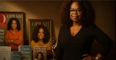 Oprah Winfrey standing beside her magazine covers and books.