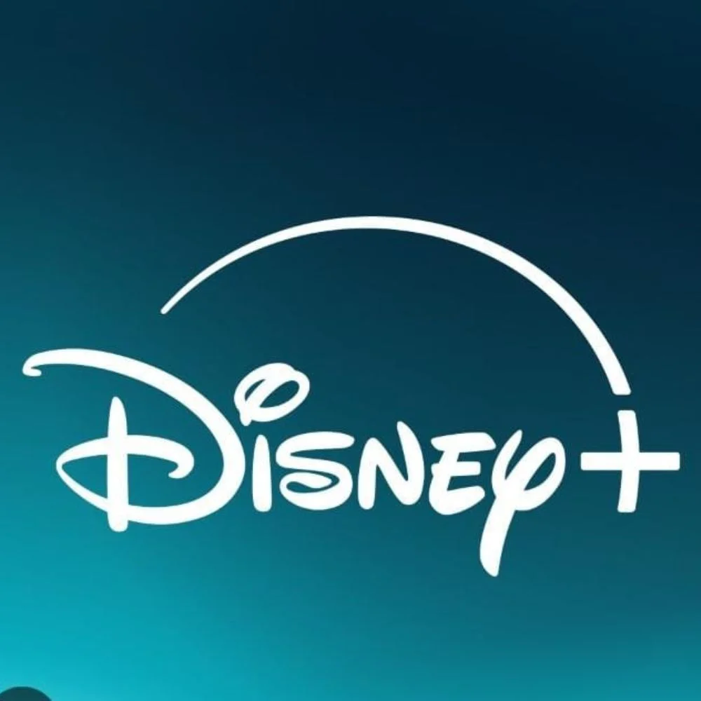 Disnep+ logo glowing on a dark screen